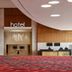 Pickering Casino Resort lobby in Pickering with red patterned carpet, wood-paneled walls and check-in desk