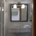 Hotel Villa Policreti in Aviano bathroom with marble sink, framed mirror and glass shower