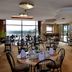 Road Lodge Bloemfontein Airport breakfast room with tables, chairs and large windows overlooking Bloemfontein