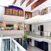 Hotel Boutique Plaza Doradas in San José del Cabo, bright atrium with upper-level walkways and white railings