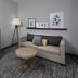 Country Inn & Suites by Radisson, Asheville West room with sofa, coffee table, lamp and wall art