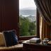 Grand Serai Congress & Spa in Ioánnina: window view of lake and mountains from a room with tea service