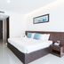 Phranang Place- Sha Extra in Krabi: a guest room with king bed, wall-mounted TV, and wooden desk