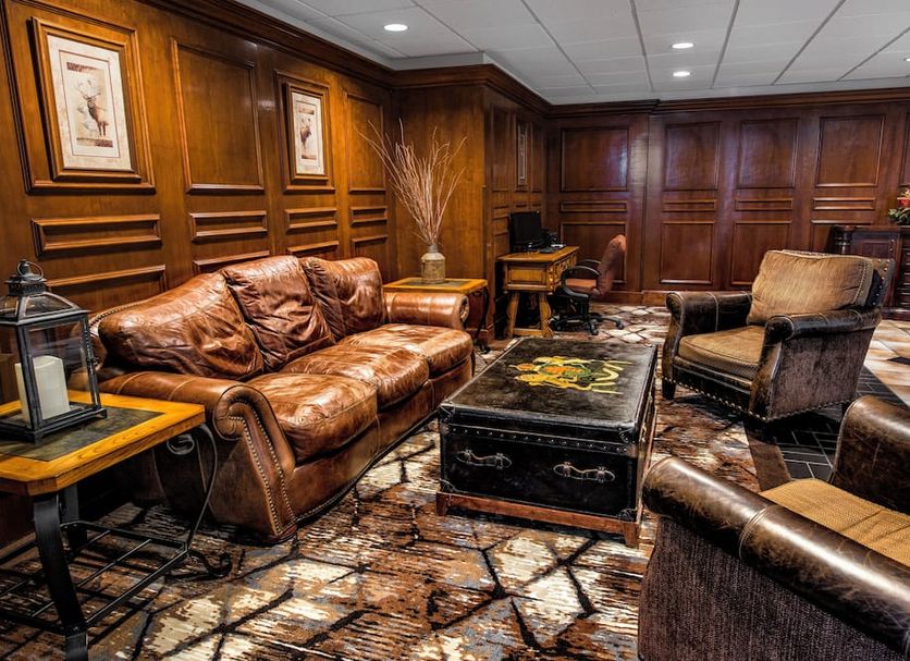 Lodge Of The Ozarks in Branson, cozy wood-paneled lobby with leather seating and a coffee table