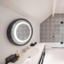 Hana Lodge in Hamurana bathroom with circular lit mirror, double vanity, and tiled walk-in shower