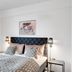 Hotel Hjallerup Kro room in Hjallerup with a quilted bed, bedside lamps and framed wall art.