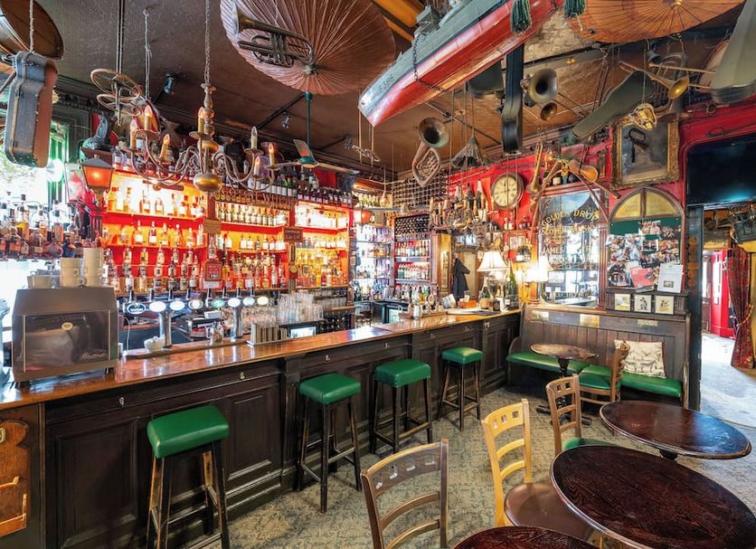 The Lane Hotel, Edinburgh: eclectic hotel bar with stools, shelves of bottles, and vintage decor
