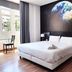 Flats Friends Plaza de la Reina Valencia room with double bed and Earth mural wall
