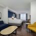 City Express by Marriott Washington, DC Northeast room with sofa, bed, desk and yellow chair