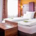 Tiptop Hotel Burgschmiet Garni, Nuremberg: twin beds with white linens and wood headboard in a guest room