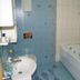 Hotel Stella di Mare in Bečići bathroom with bathtub, sink, blue-tiled shower and floral tile accents