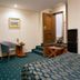 Caro Horoscop Hotel Bucharest room with bed, chair, small table, and wooden door by steps