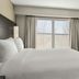Residence Inn by Marriott Davenport guest room with king bed, TV, dresser and window view