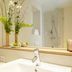 Flottwell Berlin Hotel bathroom with vanity sink, mirror, shower and flowers in Berlin