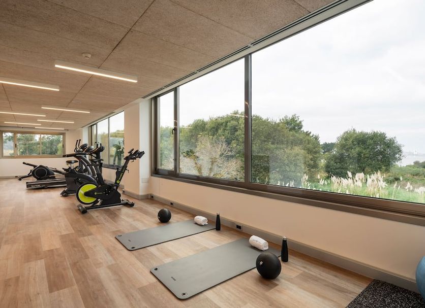 Aparthotel Attica21 As Galeras gym in Oleiros with exercise bikes, mats and large windows