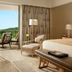 Mulia Resort in South Kuta luxury room with king bed, seating area, and balcony ocean view