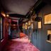 Le Moulin de la Wantzenau in La Wantzenau, dimly lit hallway with red carpet and staircase