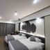 Zhehai Hotel Ningbo guest room with two twin beds and a large projection screen in Ningbo