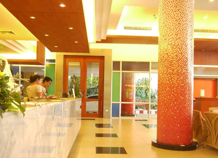 Long Beach Cha-am Hotel lobby with reception desk, mosaic column and bright open seating area