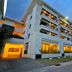 Grand Kuta Hotel and Residence in Kuta exterior with lit balconies at dusk