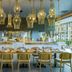 Novotel Muscat Airport restaurant interior in Muscat with hanging wicker lights and a long dining table