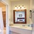 Silver Sands Motel Rockaway Beach bathroom vanity with mirror and sink beside a shower