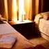 Hosteria La Raclette in San Martín de los Andes: two twin beds with bedside lamp and warm bedroom lighting