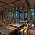 JR Kyushu Hotel Kumamoto dining area with wooden tables, chairs, and large windows