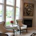 Belamere Suites Hotel in Perrysburg guest room with fireplace, large windows, seating, and bench