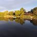 Ruttger's Bay Lake Resort in Deerwood with a calm lake reflecting trees and docks at sunset