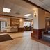 Quality Inn & Suites Williamsport lobby with leather seating and tiled floors