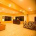 Hotel Woodrina in Shimla lobby with wood-paneled ceiling, sofas, reception desk, and bright lighting