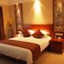 Sanqingshan Jinshawan Holiday Hotel Shangrao guest room with king bed and warm lighting