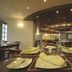 Cherry Maryski Hotel Alexandria restaurant dining room with set tables and warm lighting
