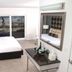 Lotus Boutique Inn & Suites, Ormond Beach guest room with king bed and balcony view