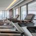 137 Pillars Residences Bangkok gym with treadmills, exercise bikes and city skyline views