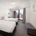 The York by Swiss-Belhotel in Sydney guest room with two beds, balcony doors and city view