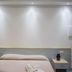 B&B Il Cavaliere in Santa Domenica bedroom with bed, bedside lamps, and wall lights