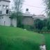 Himgiri Resorts in Dharamshala with a green hillside lawn, trees, and a resort building