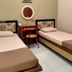 Patria Garden Hotel, Blitar: twin beds with a small table, round mirror, and wall hanging in a simple room