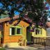 Pousada Charm Canela in Canela, rustic chalet with green windows and purple blossoms
