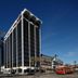 Canal Street hotel in New Orleans with tall tower, palm trees and a red streetcar on the street
