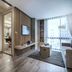 Tastoria Collection Sukhumvit in Bangkok, modern hotel suite with bedroom, living area, and floor-to-ceiling window
