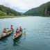 The Stavrand Russian River Valley in Guerneville: guests canoe on a calm river surrounded by forested hills