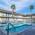 Motel 6 El Centro courtyard with outdoor pool and palm trees
