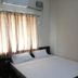 Sr Residency, Tiruchirappalli guest room with double bed, air conditioner and curtained window