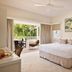 Atlantic Byron Bay room with king bed, balcony seating and palm-tree view in Byron Bay