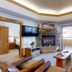 Canyon Creek in Steamboat Springs living room with fireplace, TV, leather seating and balcony door