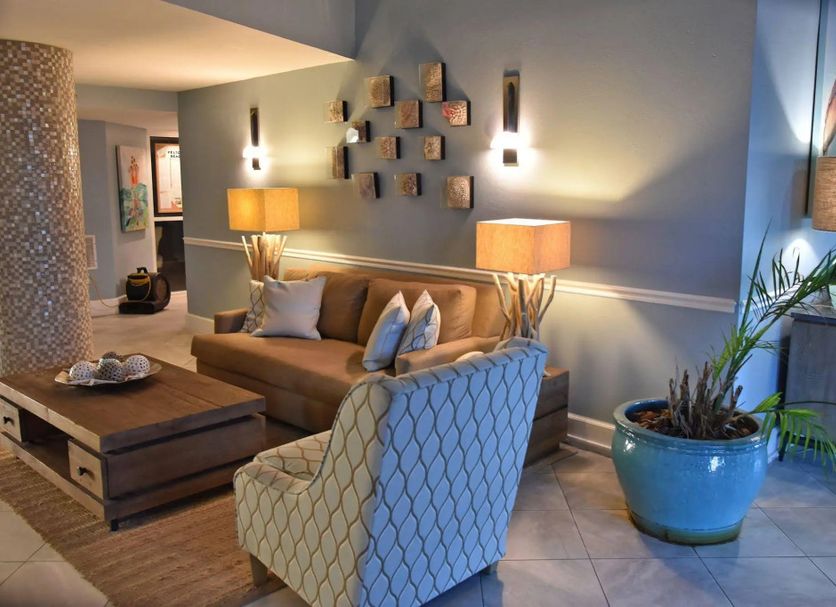 Pelican Beach Resort & Conference Center in Destin lobby seating area with sofa, armchair and lamps