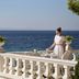 The Danai in Nikiti: seaside terrace with ocean view and a woman setting a table